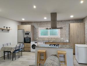 a kitchen with a counter and a table in it at LA BRISA in Cádiz