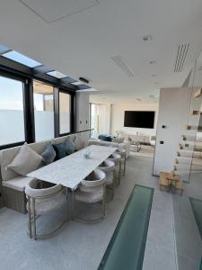 a large living room with a large table and chairs at MyBlueVista LUXURY WELLNESS VILLA La Mer NEAR MONACO in Roquebrune-Cap-Martin