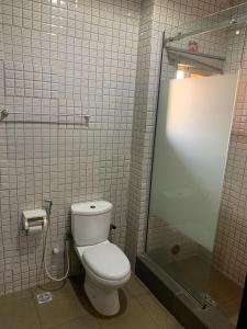 a bathroom with a toilet and a shower at Hotel Fountain Blu in Abeokuta