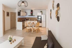 a kitchen and living room with a table and chairs at Le Cocon Manceau in Le Mans