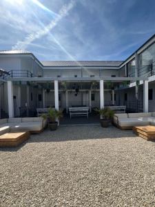 a large building with couches and a patio at Vila Yanis Vama Veche in Vama Veche