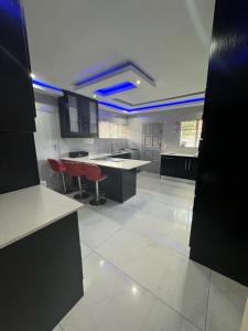 a large kitchen with red chairs in a room at Icebolethu Guest House in Standerton