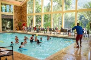 a group of people in a swimming pool at Hotel Vila Verde in Nova Friburgo
