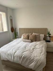 una camera bianca con un grande letto con cuscini di 269 Main Street 3 bedrooms Gem a Gibilterra