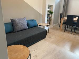 a living room with a couch and a table at Apartament Bulwar Nadmorski in Gdynia