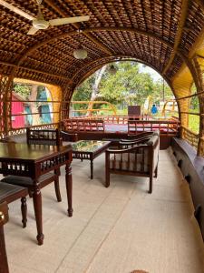 a room with a table and benches in a play room at Thara's Houseboat in Alleppey