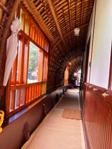 a hallway of a train car with a bow at Thara's Houseboat in Alleppey