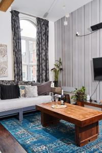 a living room with a couch and a table at Satori Serviced Apartments in Manchester