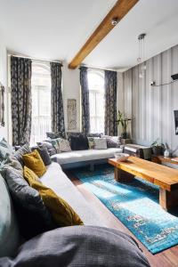 a living room with a couch and a table at Satori Serviced Apartments in Manchester