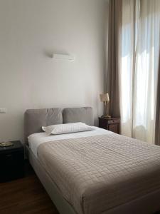 Postel nebo postele na pokoji v ubytování Residenza Scaligera