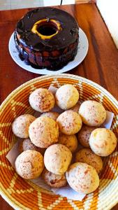 a basket of cookies and a cake on a table at Pousada Lira Praieira Paraty in Paraty