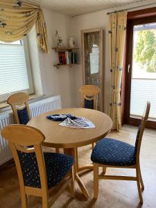 a dining room with a wooden table and chairs at Ferienhaus-Pahl-in-Wolfshagen in Wolfshagen