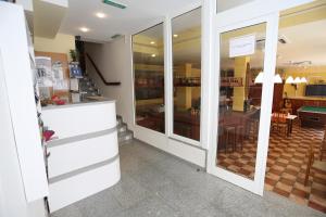 a restaurant with glass doors and a dining room at Royal Inn Aparthotel in Lloret de Mar