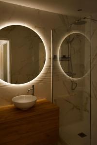 a bathroom with a sink and a mirror at Parisian style apartment in Maisons-Alfort