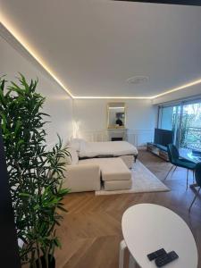 a living room with a couch and a table at Parisian style apartment in Maisons-Alfort
