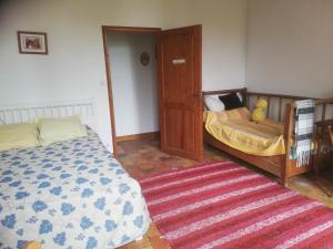 - une chambre avec un lit et un tapis dans l'établissement Gîte de la glycine, à Marmande