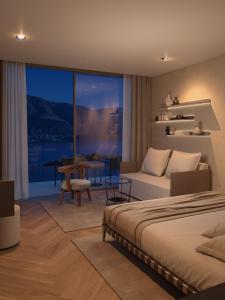 ein Schlafzimmer mit einem Bett, einem Sofa und einem Tisch in der Unterkunft Exclusive Boutique Hotel Elisabetta in Ronco sopra Ascona
