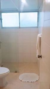 La salle de bains est pourvue d'une douche, de toilettes et d'une fenêtre. dans l'établissement Appartamento Mustique Juan Dolio fronte mare, à Juan Pedro