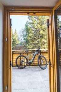 a bike is parked outside of a door at Rogla Alpina Residence in Zreče