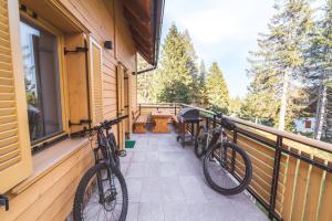 two bikes parked on a balcony of a house at Rogla Alpina Residence in Zreče