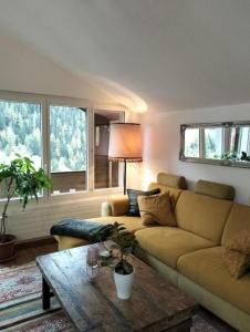 a living room with a couch and a table at Le Sorelle Apartments 2 in Ferden