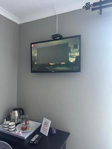 a flat screen tv hanging on a wall at Maphuthi River Lodge in Ga-Manapane