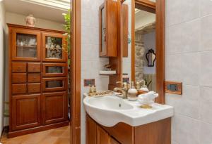 ein Bad mit einem Waschbecken und einem Spiegel in der Unterkunft Affascinante appartamento nel Castello. in Moniga