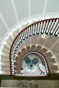 a spiral stairway with a white ceiling at 2 Chesham Hotel in London