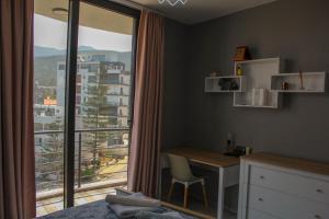 a bedroom with a desk and a large window at 2+1 Girne CC Towers in Kyrenia