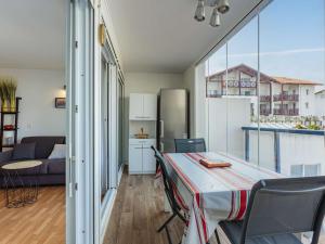 Habitación con mesa con sillas y cocina. en Appartement Hendaye, 2 pièces, 6 personnes - FR-1-2-285, en Hendaya