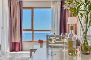 a dining room with a table with two glasses of wine at Dreams in La Mer in Golden Sands