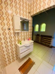 W łazience znajduje się umywalka i lustro. w obiekcie Chácara Aconchegante com Piscina e Salão de Festas w mieście Embu