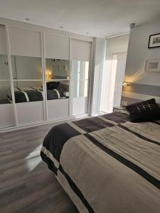 a bedroom with a large bed and a large window at Descanso urbano Pamplona in Mutilva Alta +26 photos