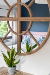 a mirror in a room with a potted plant at Przystań Stegna in Stegna