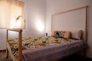 a bedroom with a bed with a quilt on it at Parrot Palazzo in Nea Kallikrateia