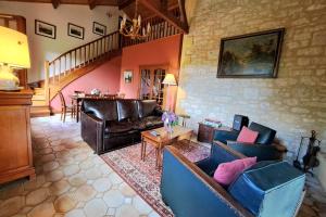 a living room with leather couches and a table at With the family -A peaceful stay in the countryside- spa 8-10 pers in Gaugeac