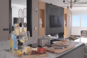 a kitchen with a table with a plate of food and wine at Blue Marina Suites - Boutique Apartments in Arrecife