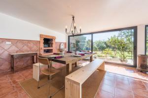 a dining room with a table and a large window at GuestReady - Sunset Pool House in Esposende