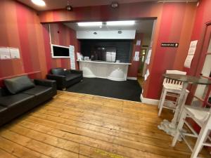 a living room with red walls and a bar at Sea Side Hotel in Skegness