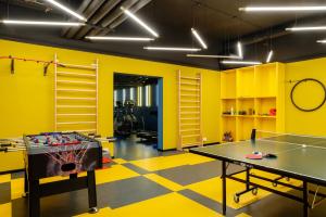 a gym with a ping pong table in a room at Student Depot Lublin Apartamenty in Lublin