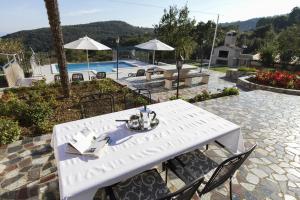 a white table with a book on it next to a pool at Apartments Rajkovic in Labin