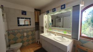 a bathroom with two sinks and a mirror at Lacustrebnb in Choisy +45 photos