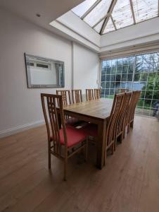a dining room with a wooden table and chairs at Large 6 Bedroom house in Hendon in Hendon