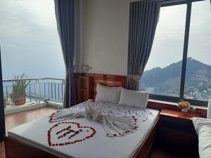 a bedroom with a bed with two hearts on it at Ruby Tam Đảo in Tam Ðảo