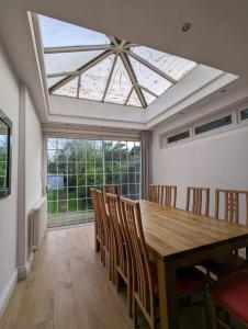 a dining room with a wooden table and chairs at Large 6 Bedroom house in Hendon in Hendon