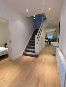 a hallway with a staircase in a house at Large 6 Bedroom house in Hendon in Hendon