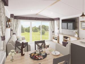 a kitchen and living room with a table with food on it at Llwyngwair Manor, Newport, PEMBROKESHIRE in Newport