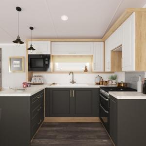 a kitchen with black and white cabinets and a sink at Llwyngwair Manor, Newport, PEMBROKESHIRE in Newport Pembrokeshire