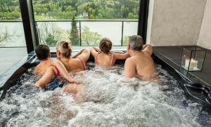 a group of people sitting in a hot tub at Hotel Kras in Jedovnice