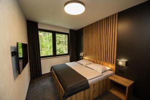 Ένα ή περισσότερα κρεβάτια σε δωμάτιο στο Hotel Kras